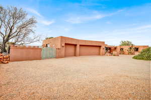 Garage featuring a gate and driveway