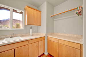 Kitchen featuring light brown cabinetry, light countertops, a mountain view, and light tile patterned flooring