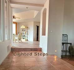 Spare room with stone tile floors and ceiling fan