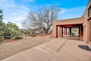 View of yard with ceiling fan, a patio, and outdoor dining space