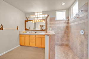 Full bath with a walk in shower and double vanity