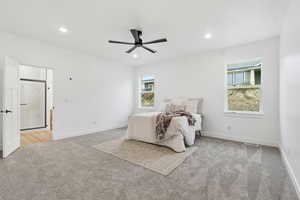 Bedroom featuring light colored carpet, ceiling fan, and recessed lighting