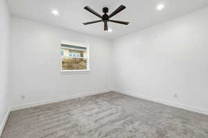 Empty room featuring carpet, recessed lighting, and ceiling fan