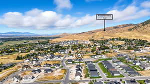 Aerial overview of property's location featuring nearby suburban area and mountains