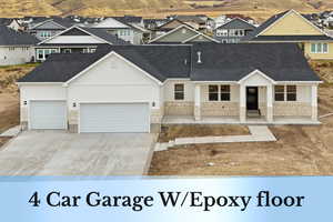 View of front facade featuring a porch, stone siding, driveway, and an attached garage