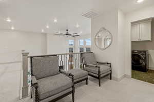 Sitting room with washer / clothes dryer, recessed lighting, an upstairs landing, carpet, and ceiling fan