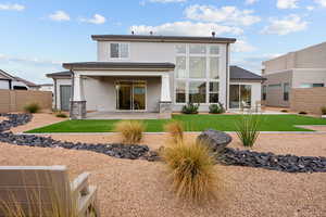 Rear view of house featuring a patio area and stucco siding