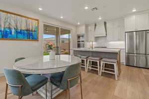 Dining room featuring light wood-style flooring, recessed lighting, and a ceiling fan