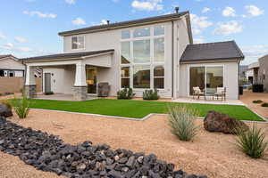 Rear view of house featuring a patio area and stucco siding