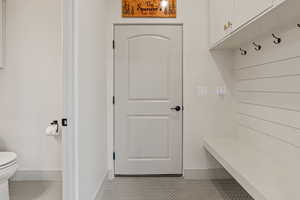 Mudroom featuring baseboards and tile patterned flooring