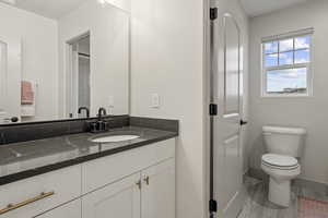 Bathroom featuring vanity and wood finished floors