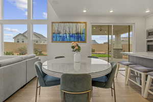 Dining area featuring light wood finished floors and recessed lighting