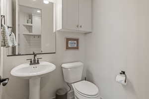 Bathroom with toilet and baseboards