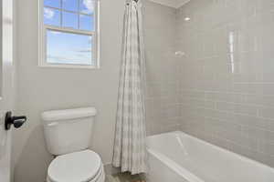 Full bath with shower / bathtub combination with curtain and toilet