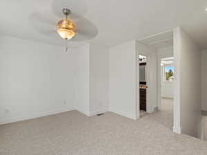 Unfurnished room with light colored carpet and ceiling fan