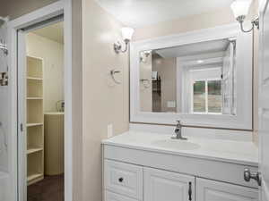 Bathroom featuring vanity and a spacious closet