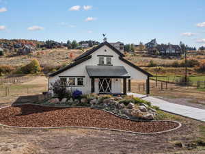 Modern farmhouse style home with a porch, a metal roof, and board and batten siding