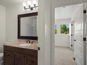 Half bathroom with vanity and a textured ceiling