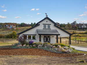 View of front facade featuring board and batten siding, a metal roof, and a standing seam roof