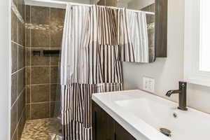 Bathroom with a stall shower and vanity