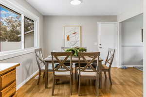 Dining area featuring light wood-style flooring and a textured ceiling