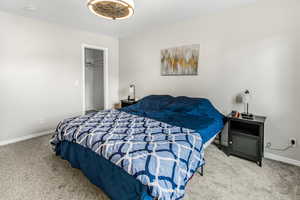 Bedroom with baseboards and carpet flooring