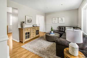 Living area featuring light wood finished floors and recessed lighting