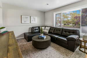 Living area with baseboards and wood finished floors