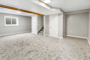 Finished basement featuring carpet floors and stairs