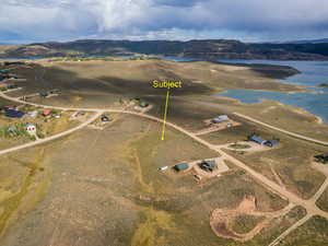 Aerial view of property and surrounding area featuring a water and mountain view