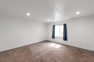 Empty room featuring carpet floors and recessed lighting