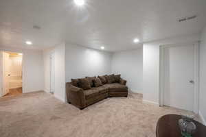 Living room with light carpet and recessed lighting