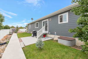 Rear view of house with a storage shed, a patio, and a fenced backyard
