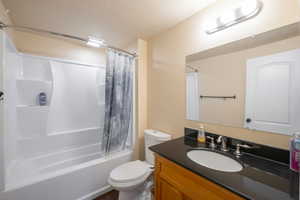 Full bathroom featuring shower / tub combo and vanity