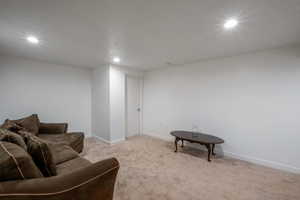 Living area with carpet flooring and recessed lighting