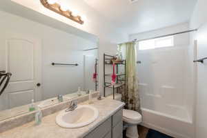 Bathroom with vanity and shower / bath combination with curtain