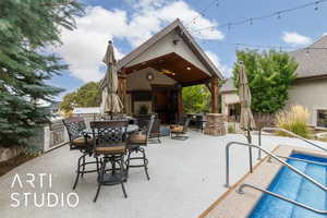 View of patio / terrace with ceiling fan, area for grilling, an outdoor pool, and an outdoor bar