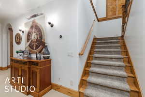 Stairs with carpet and arched walkways