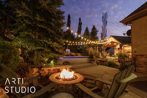 Patio terrace at dusk with a patio and a fire pit