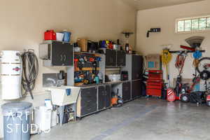 Garage featuring a central vacuum unit and a workshop area