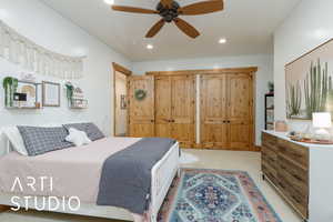 Bedroom featuring light colored carpet, recessed lighting, two closets, and ceiling fan