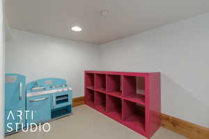 Playroom with recessed lighting and light carpet