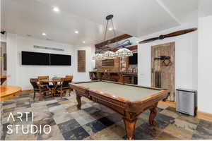 Game room featuring recessed lighting, pool table, bar area, and stone tile flooring