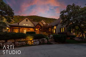 View of front facade with stone siding and a porch