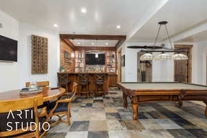 Game room featuring billiards, wet bar, recessed lighting, stone finish floors, and beamed ceiling