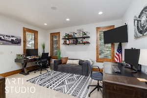 Home office featuring recessed lighting and light carpet