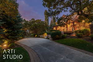 View of front facade with a front yard and stone siding