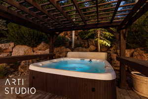 View of pool featuring a hot tub, a pergola, and a patio area