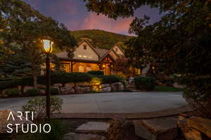 View of front of house featuring covered porch and stone siding