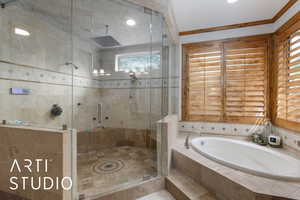 Full bathroom featuring a shower stall, a garden tub, and recessed lighting